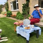 a man and dog enjoy afternoon tea